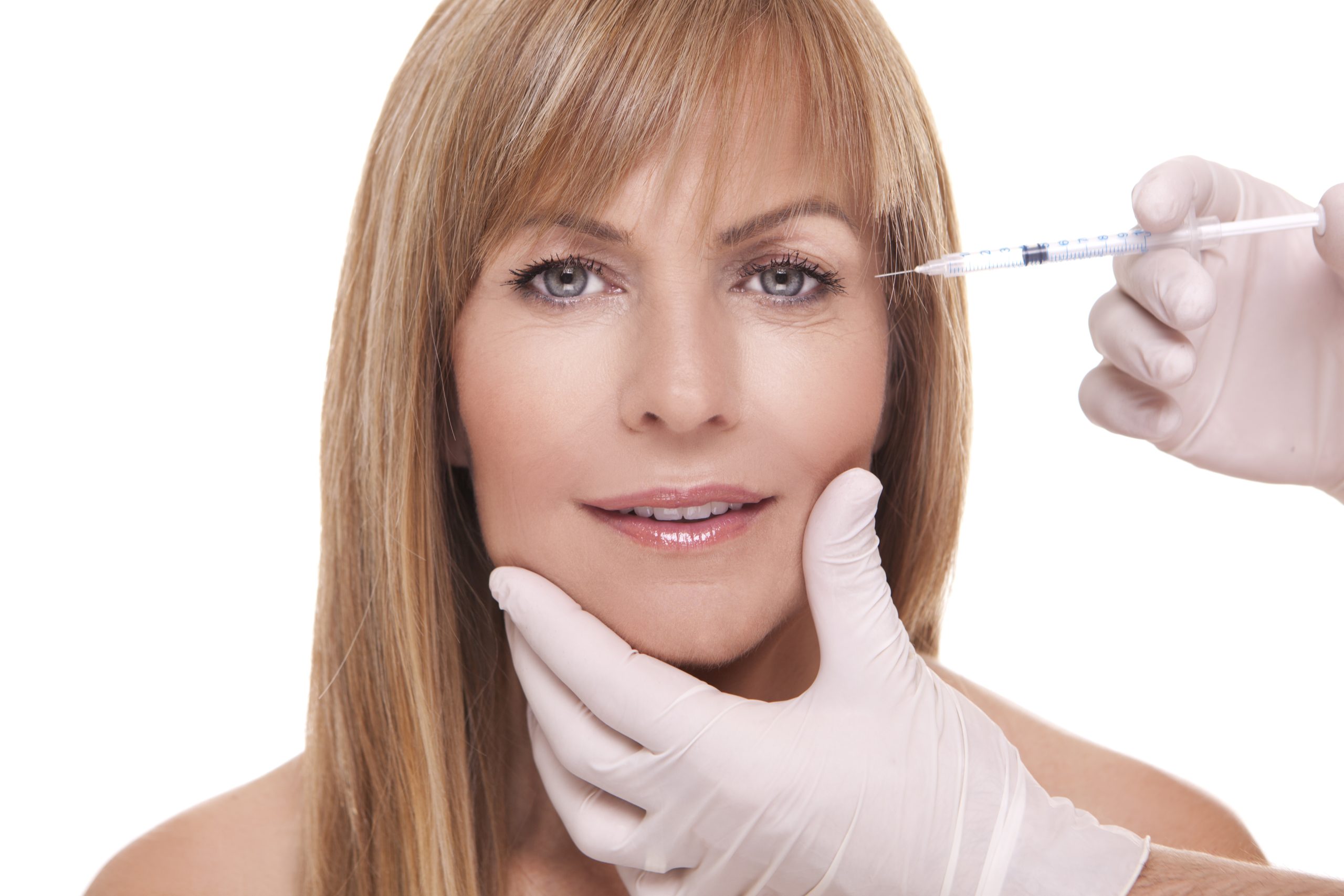 Mature women having injection of botox